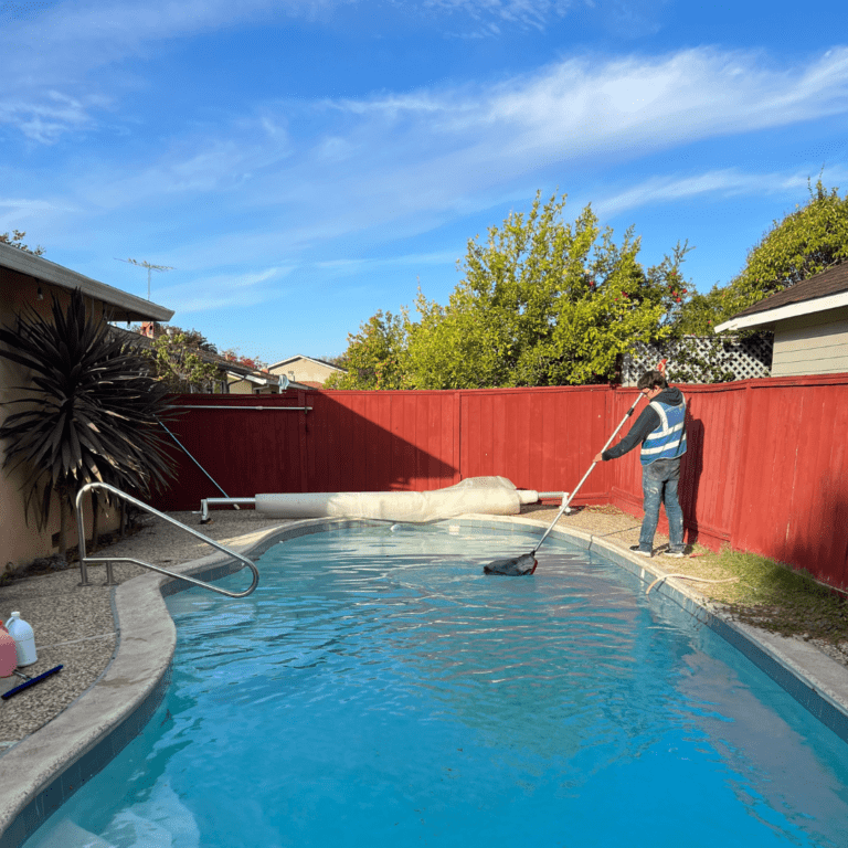 Person Cleaning Residential Backyard Pool | Sun Pointe Services